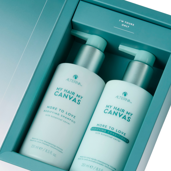 Two bottles of 'My Hair My Canvas' shampoo and conditioner in a teal box.